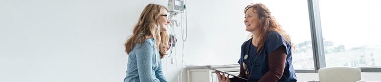 A female provider talking with female patient and smiling