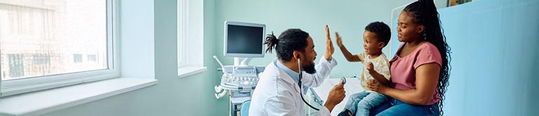 Doctor high-fiving a little child 