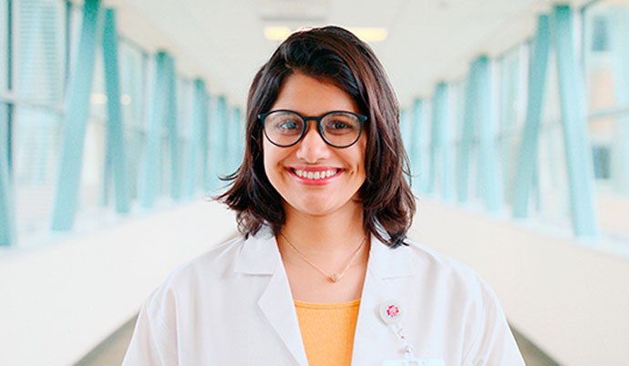 A doctor smiling in a hallway