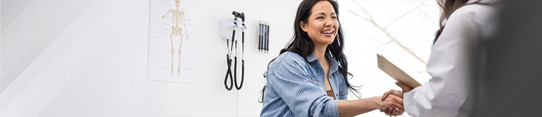 female patient shaking hands with a healthcare provider