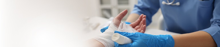 Provider wrapping patient's injured hand