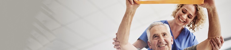 A nurse helping an elderly man do strength training