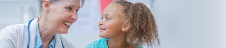 Doctor smiling at a little girl