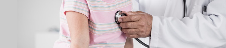 Doctor listening to girls breathing with a stethoscope 