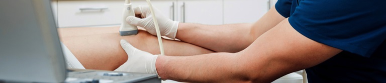 Nurse examining a patients knee