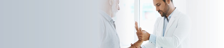 doctor examining a mans hand