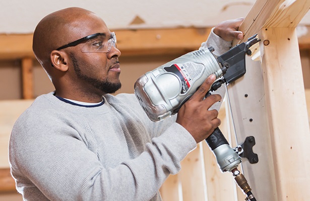 construction worker with a nail gun