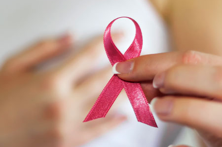 Girl holding pink ribbon