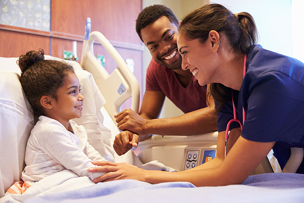 Young girl being attended to by two nurses