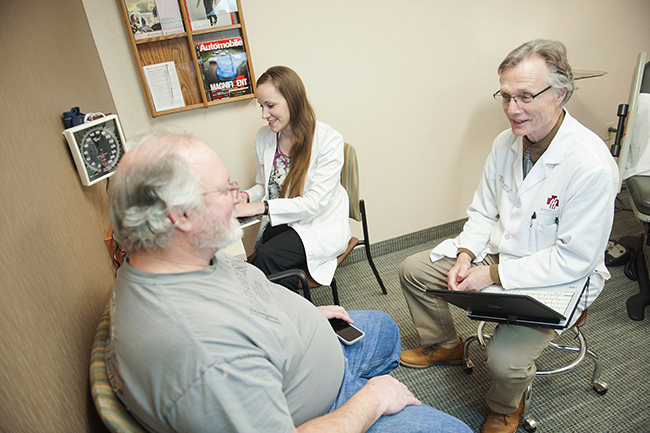 A Marshfield Clinic internal medicine physician talks with a patient at the Marshfield Center.