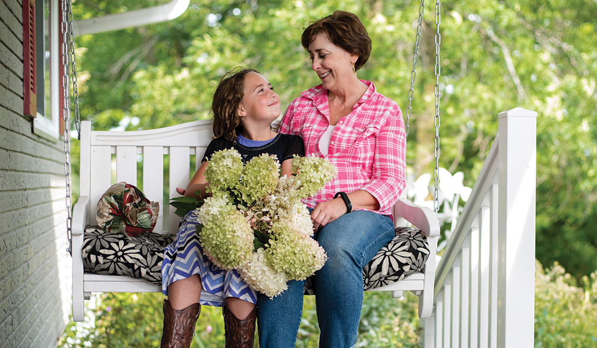 Woman and young girl sitting on a swing