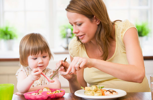 woman feeding child