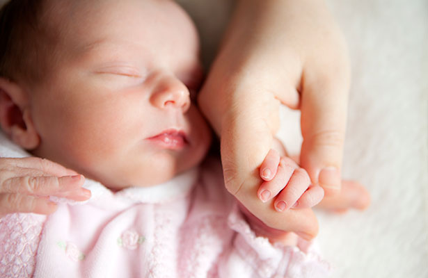 Newborn holding mother's hand - Breast milk donation