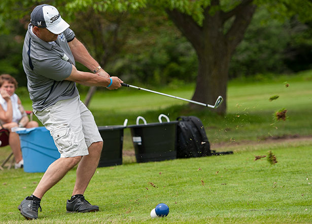 Golfer teeing off