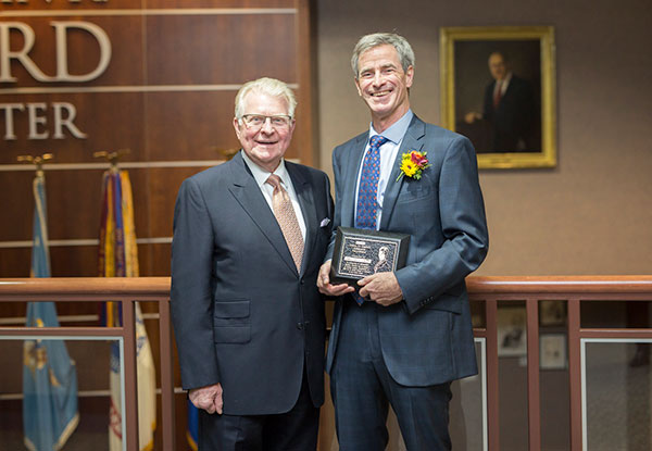 Jim Donahue, Ph.D., receives the Gwen D. Sebold Fellowship for Outstanding Research Oct. 10, from D. David "Dewey" Sebold, left.