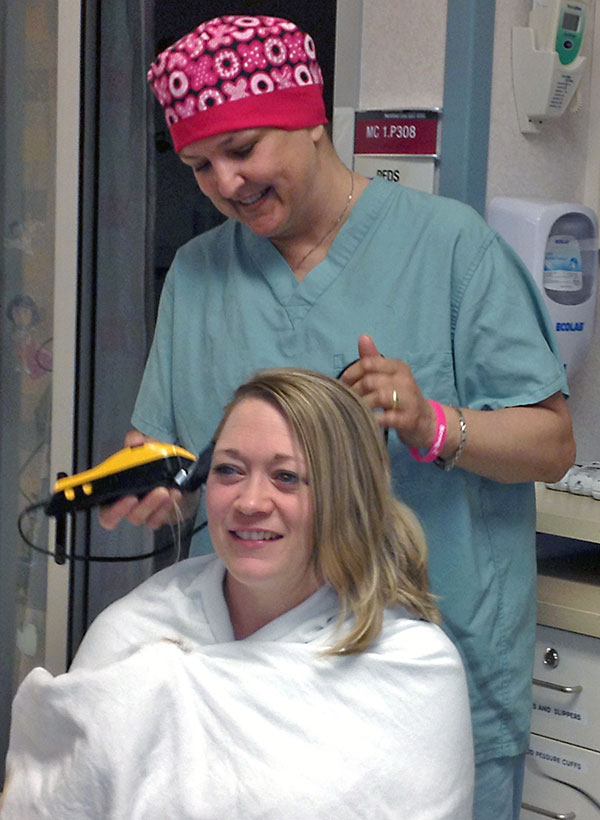 Tracy Brock having her head shaved