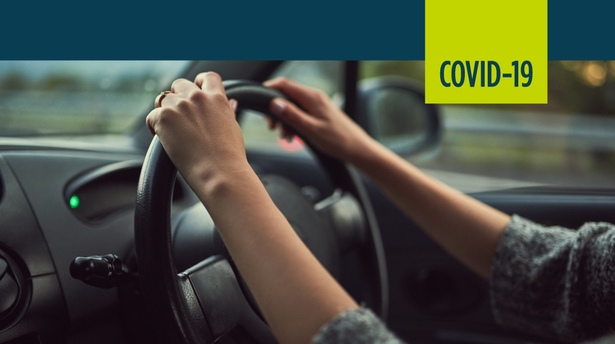 driver's hands on a steering wheel