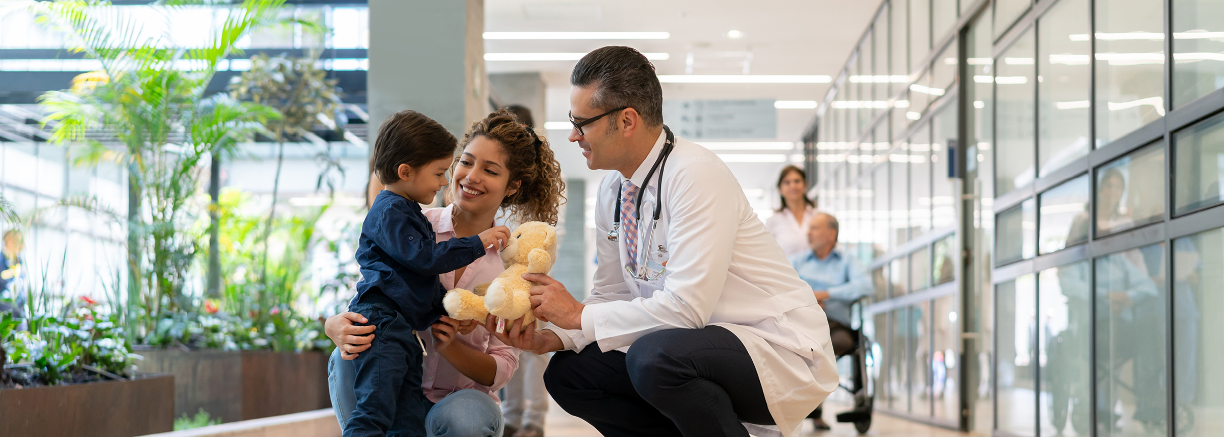 doctor with smiling mother and child