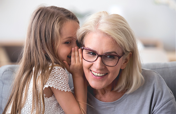 Little girls whispering into moms ears.