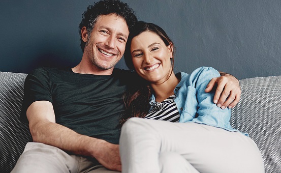 Image of couple sitting together and smiling
