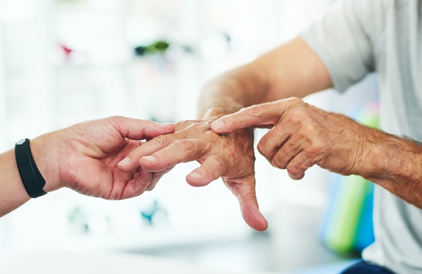 doctor examining patient's hand