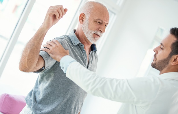 doctor examining a shoulder