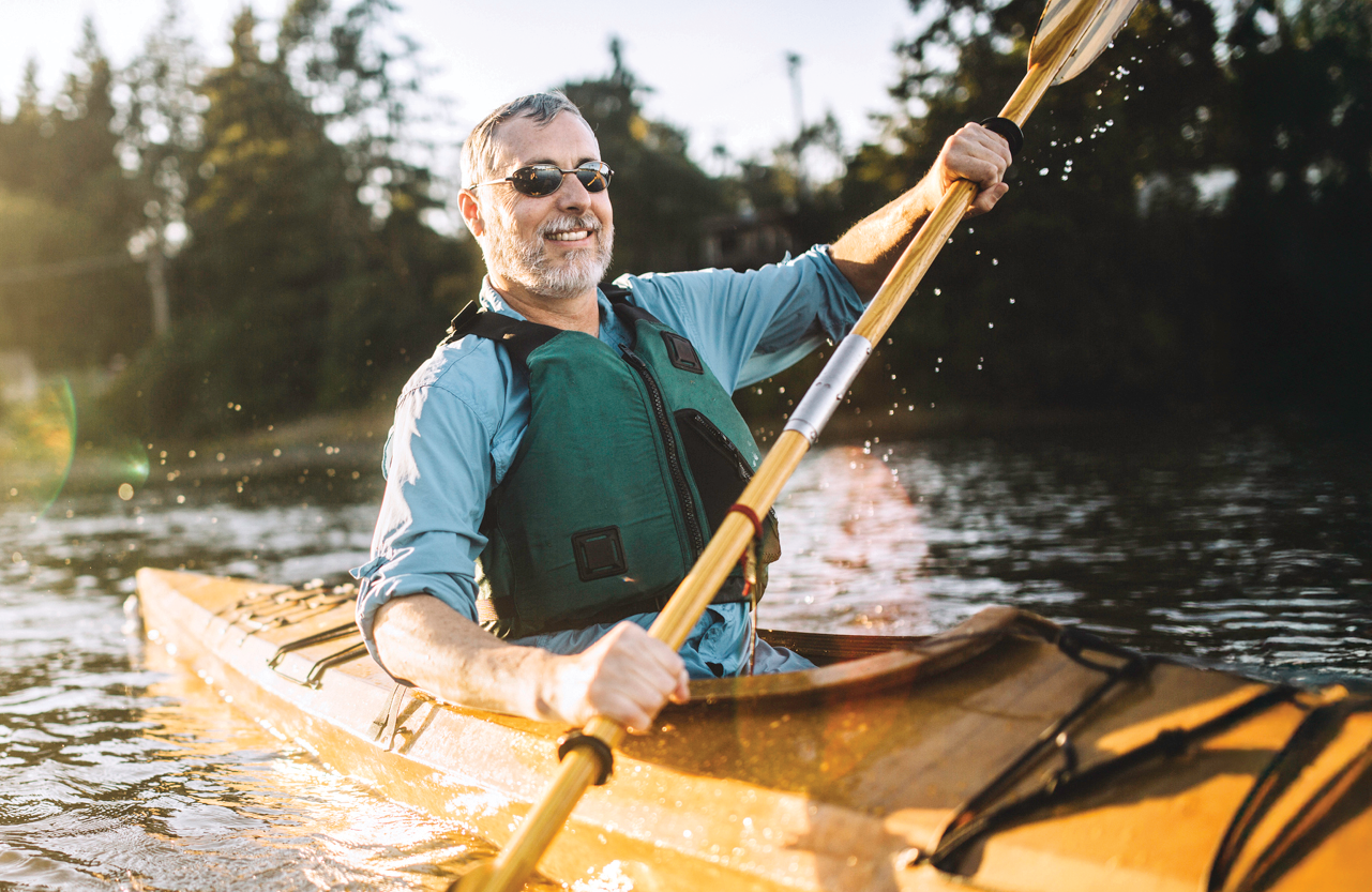 man padding a kayak
