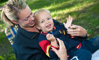 mom holding smiling child