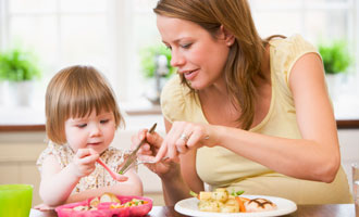 woman feeding child