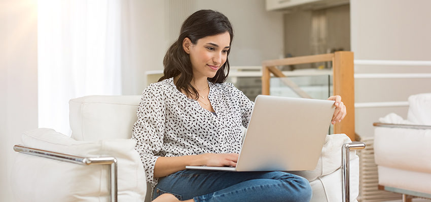 Image of individual looking at her laptop