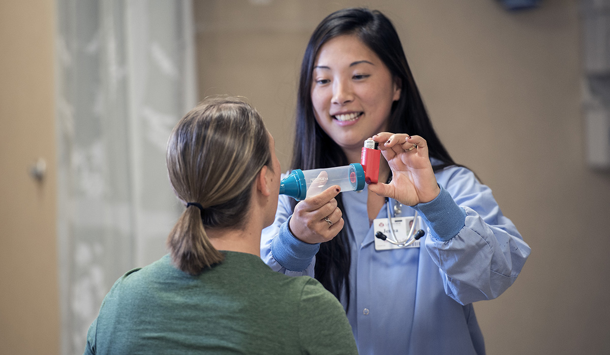 Smiling provider administering medicine to patient