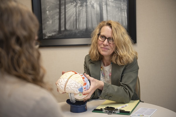 woman with model of brain